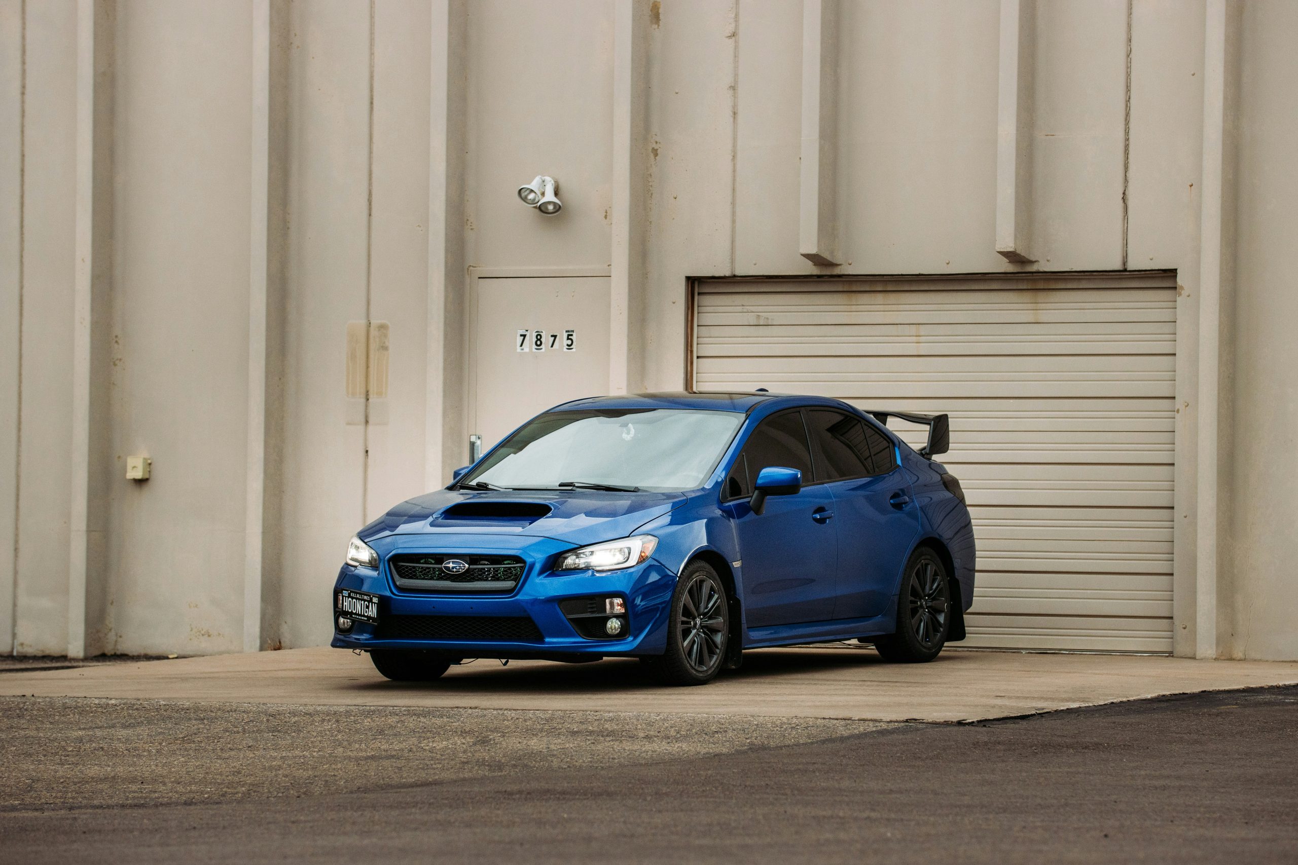 A Subaru is standing on a ramp outside a parking shutter