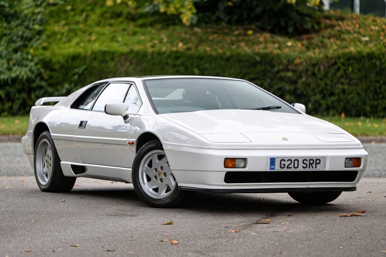 Classic Lotus Esprit sports car parked outdoors, showcasing its sleek wedge-shaped design