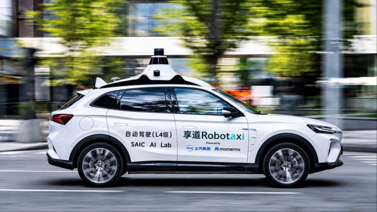 SAIC Robotaxi drives through an urban street, showcasing autonomous driving technology in motion