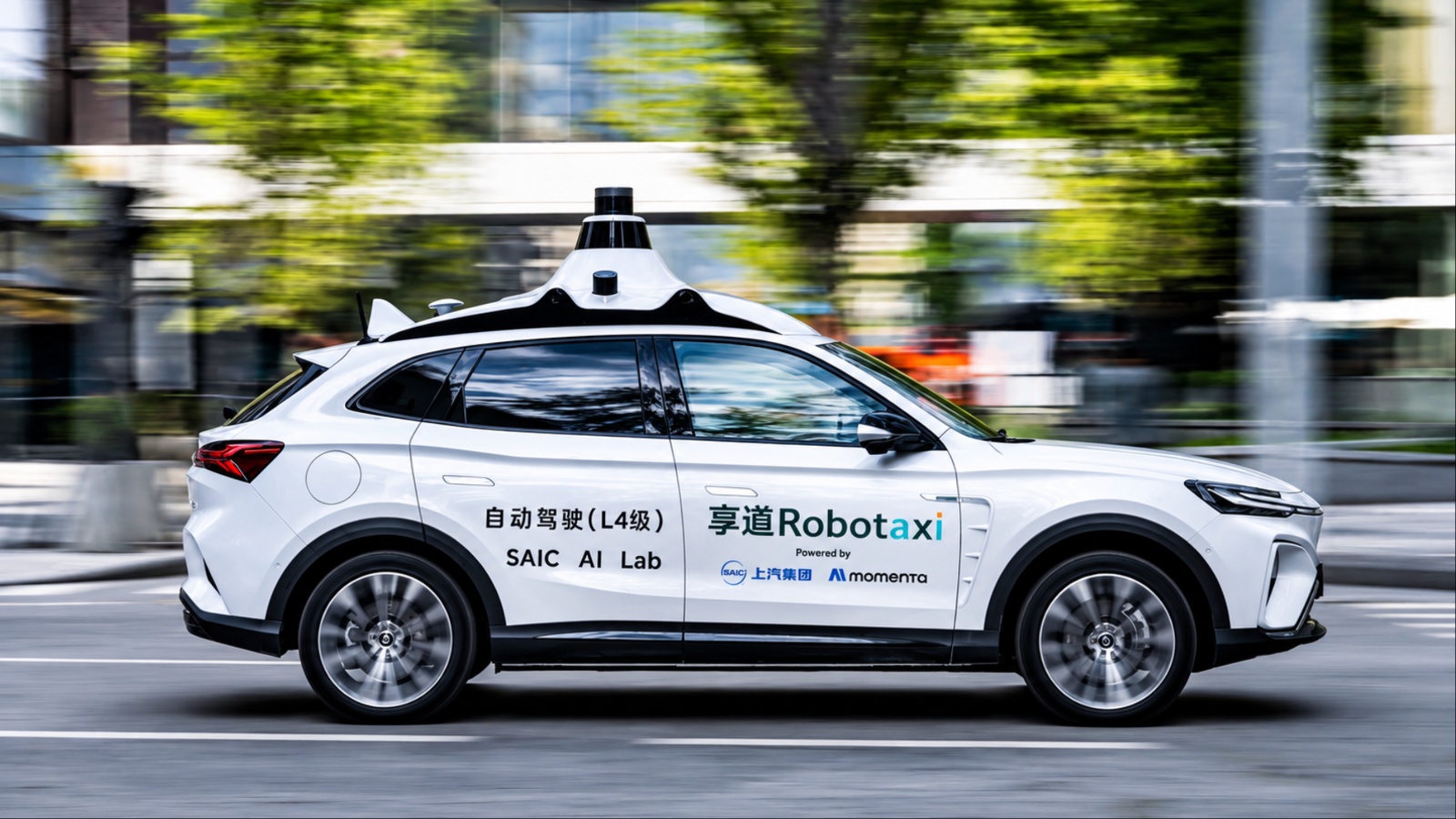 SAIC Robotaxi drives through an urban street, showcasing autonomous driving technology in motion
