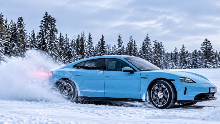 A Taycan is burning tires on a snowy road